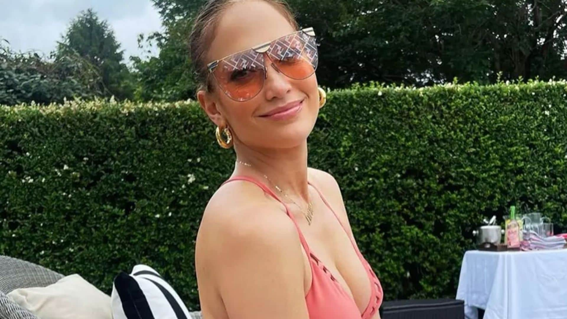 Jennifer Lopez relaxes poolside and shows off toned figure in pink swimsuit