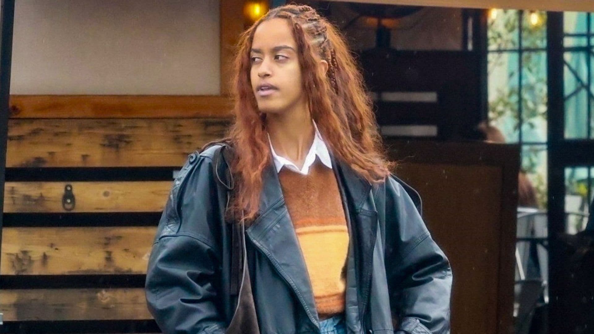 Malia Obama looks effortlessly cool as she pairs a striped sweater with a leather coat