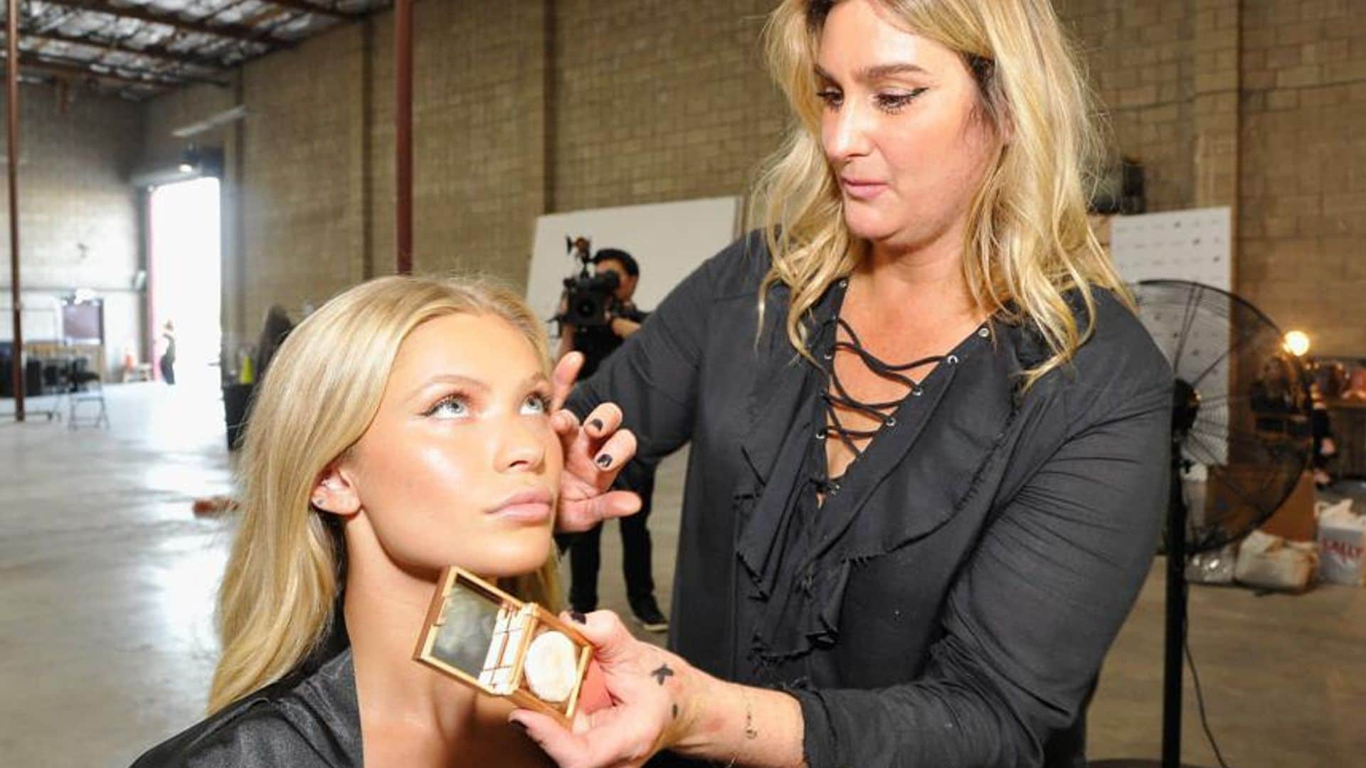 Makeup artist with a model adding foundation