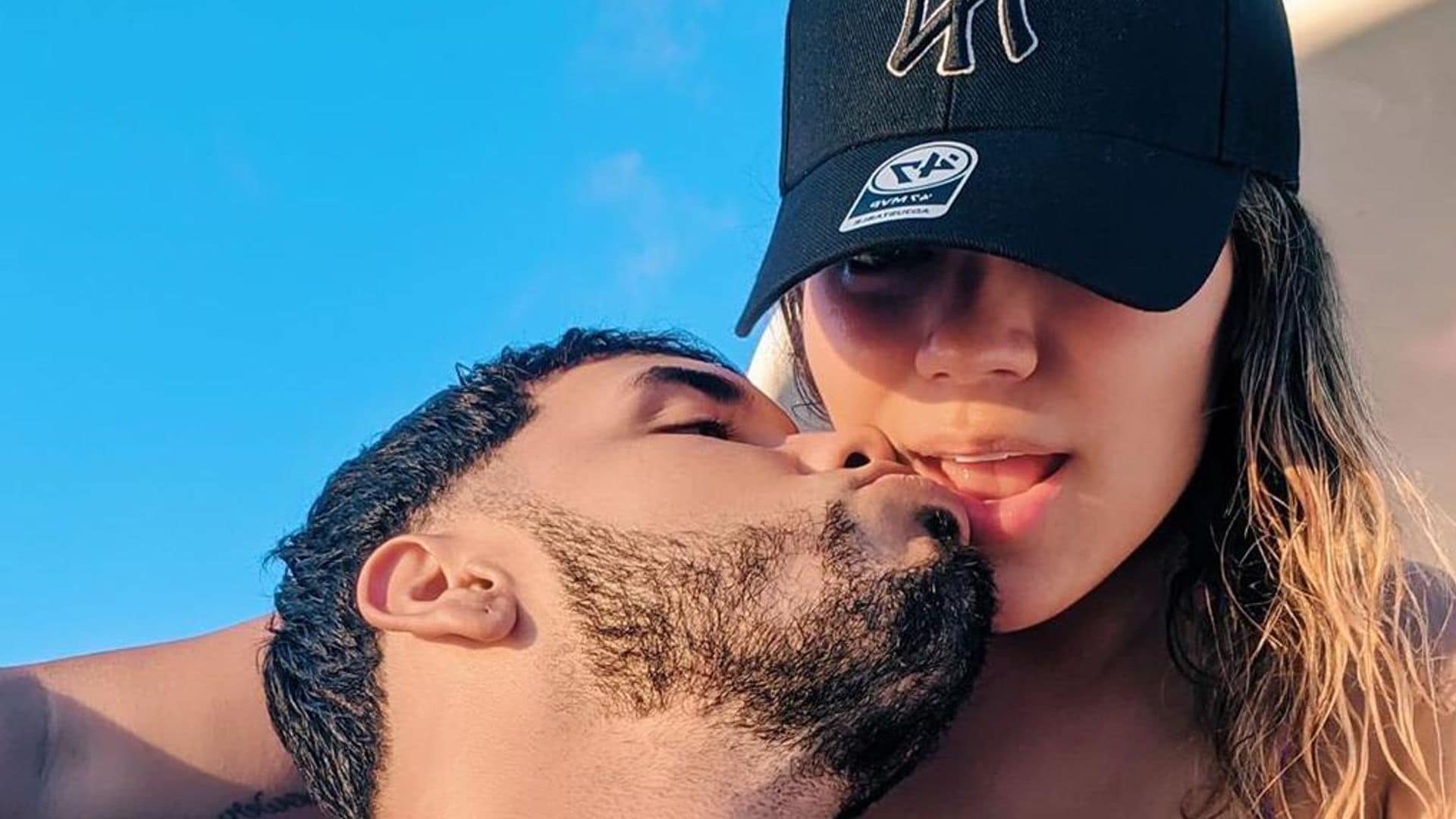 Anuel AA and Karol G share a kiss