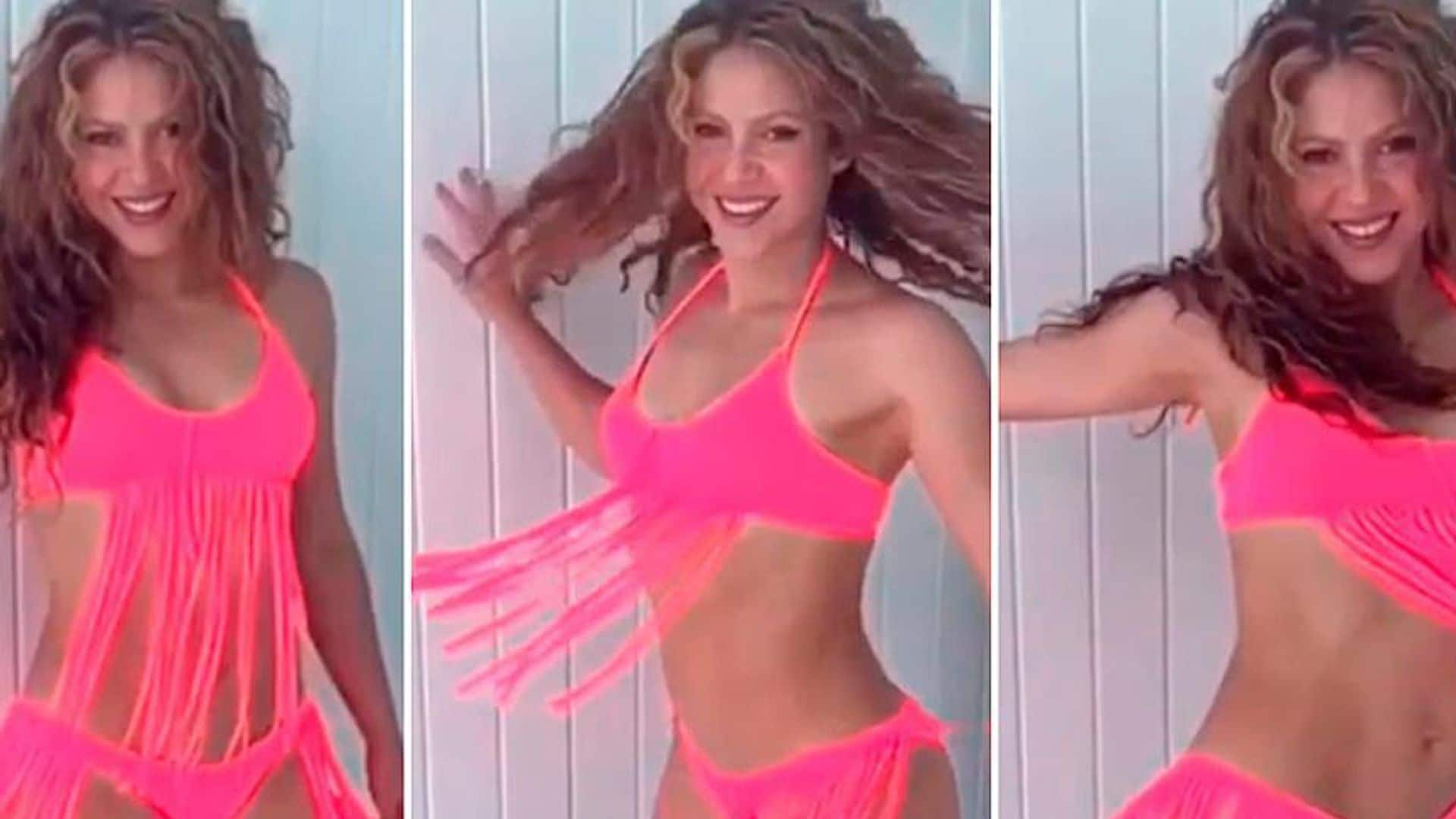 Shakira proves she's summer-ready and shakes her hips in a hot pink bikini