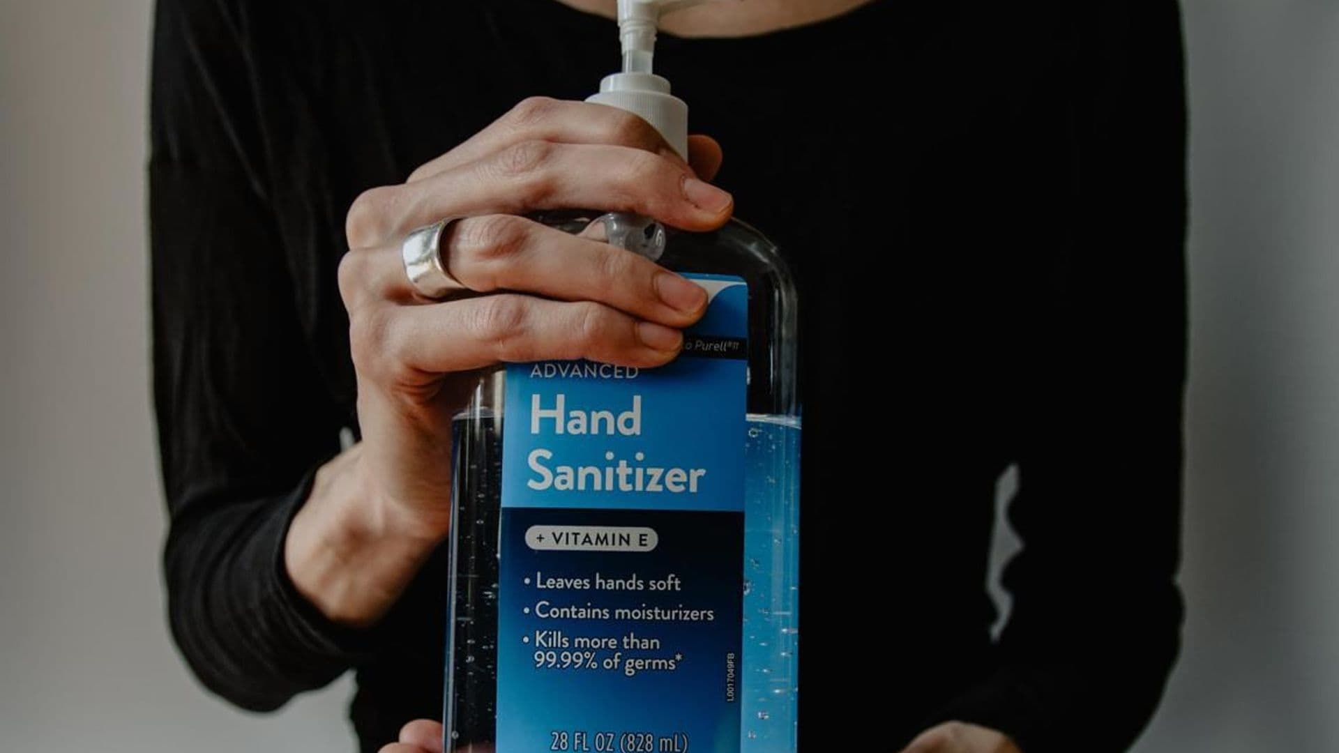 woman holding hand sanitizer