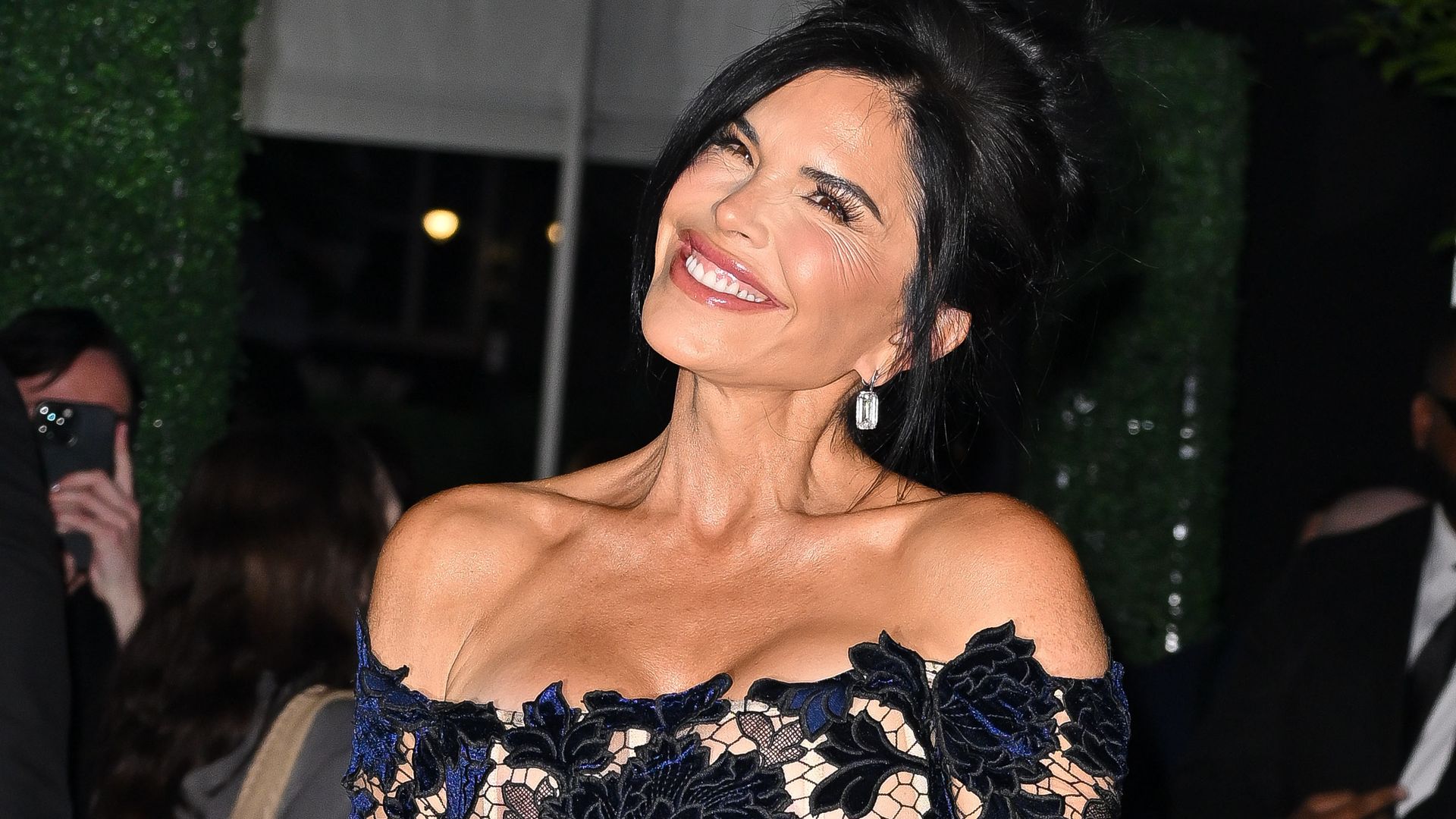 Lauren Sanchez poses in dramatic cape dress and pearl earrings at the Starlight Ball