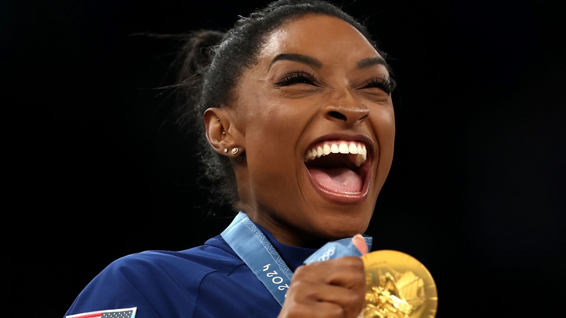 Gold medalist Simone Biles of Team United States celebrates on the podium during the Artistic Gymnastics Women's Team Final medal ceremony on day four of the Olympic Games Paris 2024 at Bercy Arena on July 30, 2024, in Paris, France. (Photo by Naomi Baker/Getty Images)