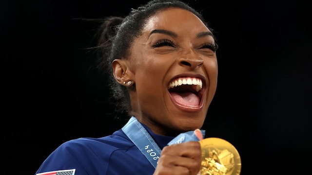 Gold medalist Simone Biles of Team United States celebrates on the podium during the Artistic Gymnastics Women's Team Final medal ceremony on day four of the Olympic Games Paris 2024 at Bercy Arena on July 30, 2024, in Paris, France. (Photo by Naomi Baker/Getty Images)