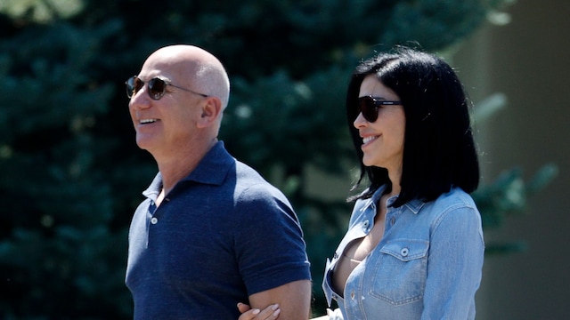 Jeff Bezos, founder of Amazon.com Inc., and Lauren Sanchez walk after the morning session during the Allen & Company Sun Valley Conference