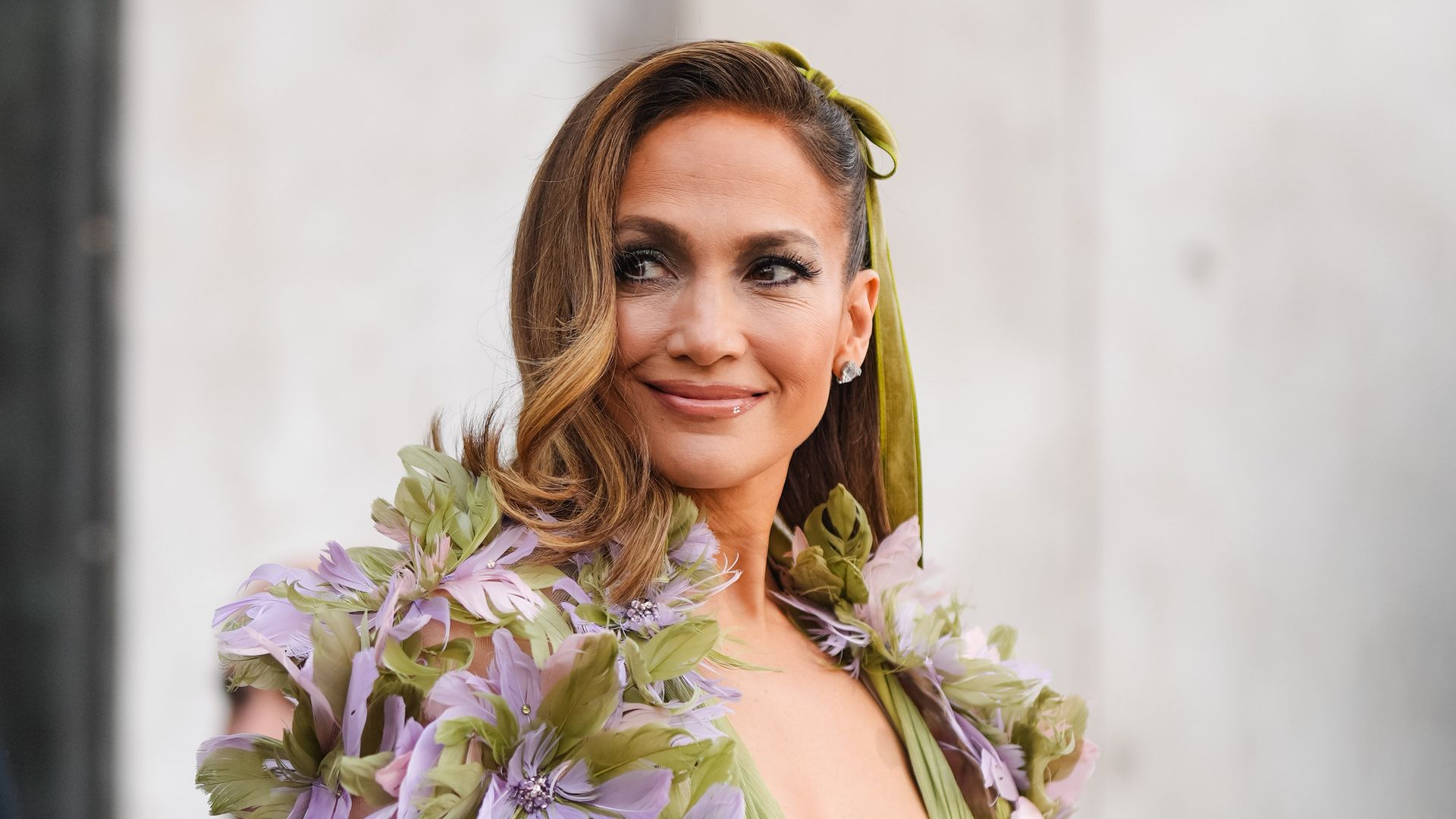 Jennifer Lopez wore a green gathered low-neck dress with floral embroidery and details outside Elie Saab on January 24, 2024, during the Haute Couture Spring/Summer 2024 as part of Paris Fashion Week in Paris, France. 