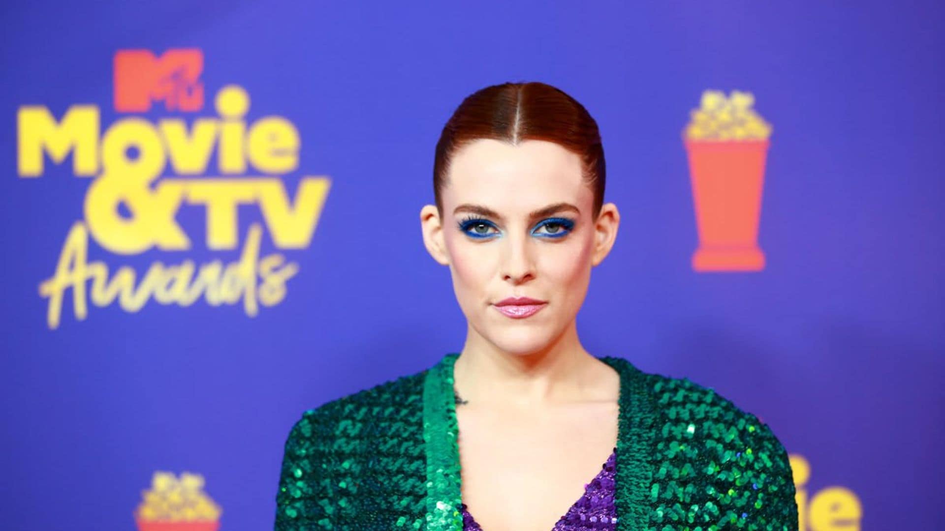 Riley Keough, daughter of Lisa Marie Presley, posed in a plunging gown in her bathroom