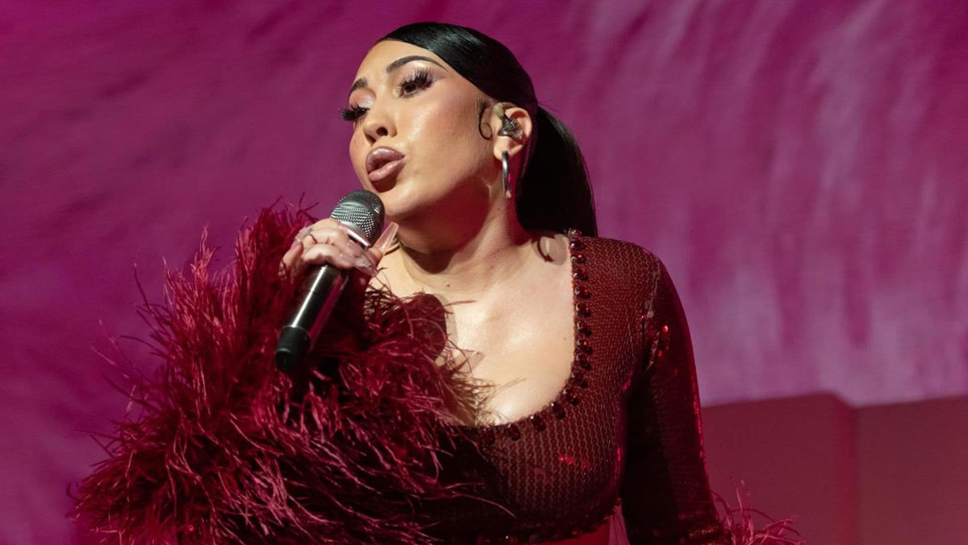 Kali Uchis shows her growing baby bump while performing on Jimmy Kimmel Live!