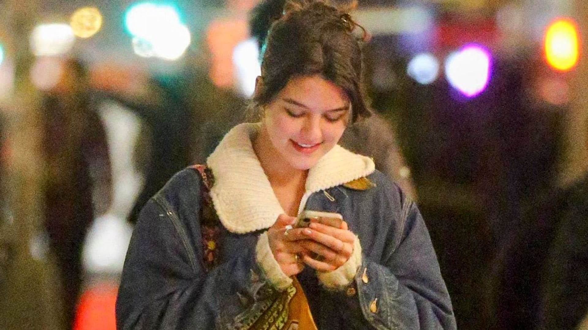 Suri Cruise can’t stop smiling while texting in NYC with a fashionable outfit