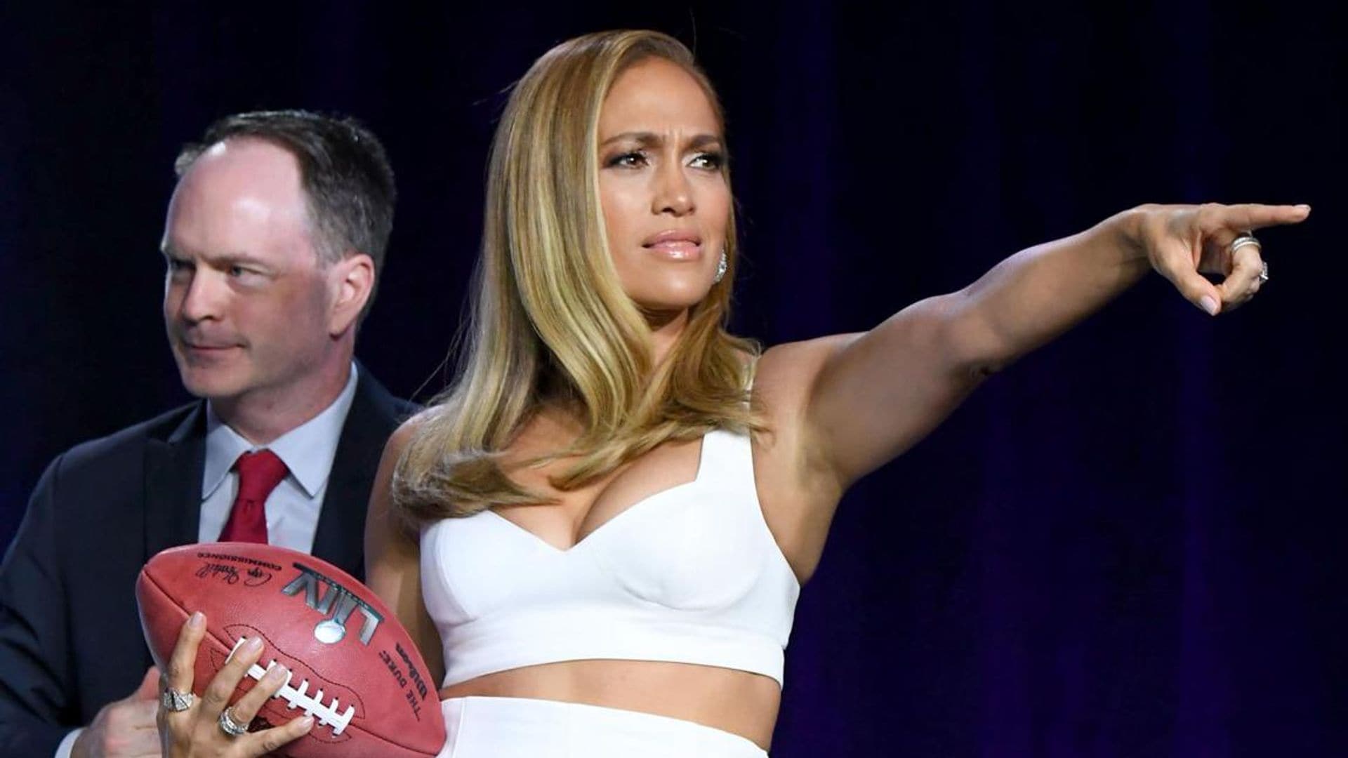 Jennifer Lopez shows off her amazing toned arms as she throws a football in white two-piece