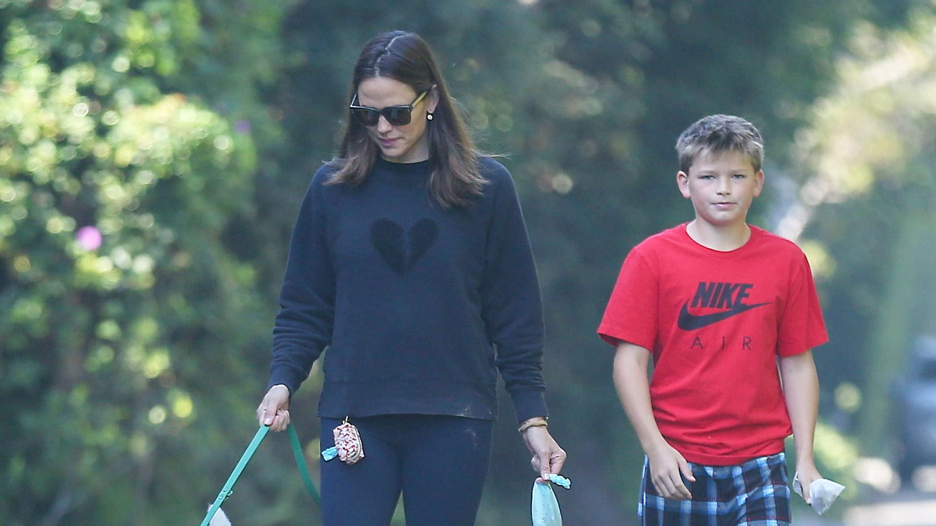 Jennifer Garner kisses Samuel Affleck while enjoying a relaxing walk with the family dog