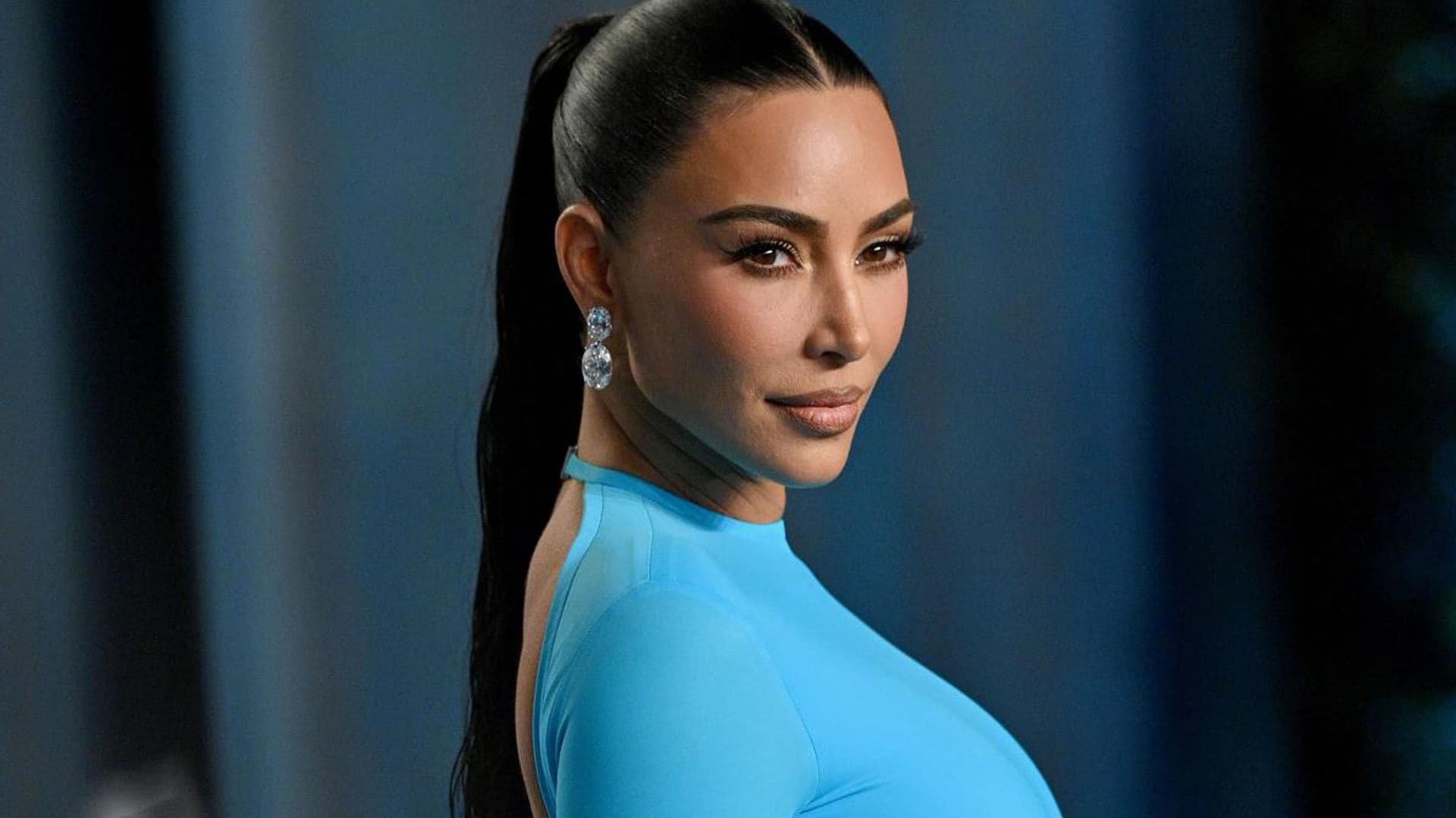 Kim Kardashian swaps her normal neutral tones for a bright blue gown at Vanity Fair Oscar party