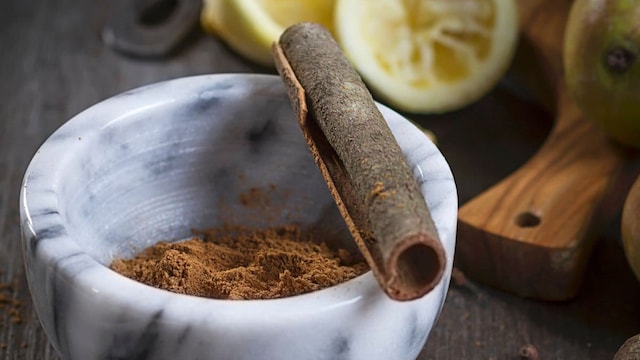 Chai spice mixture with cinnamon and cloves in a mortar