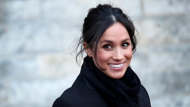 Meghan Markle in black coat with scarf