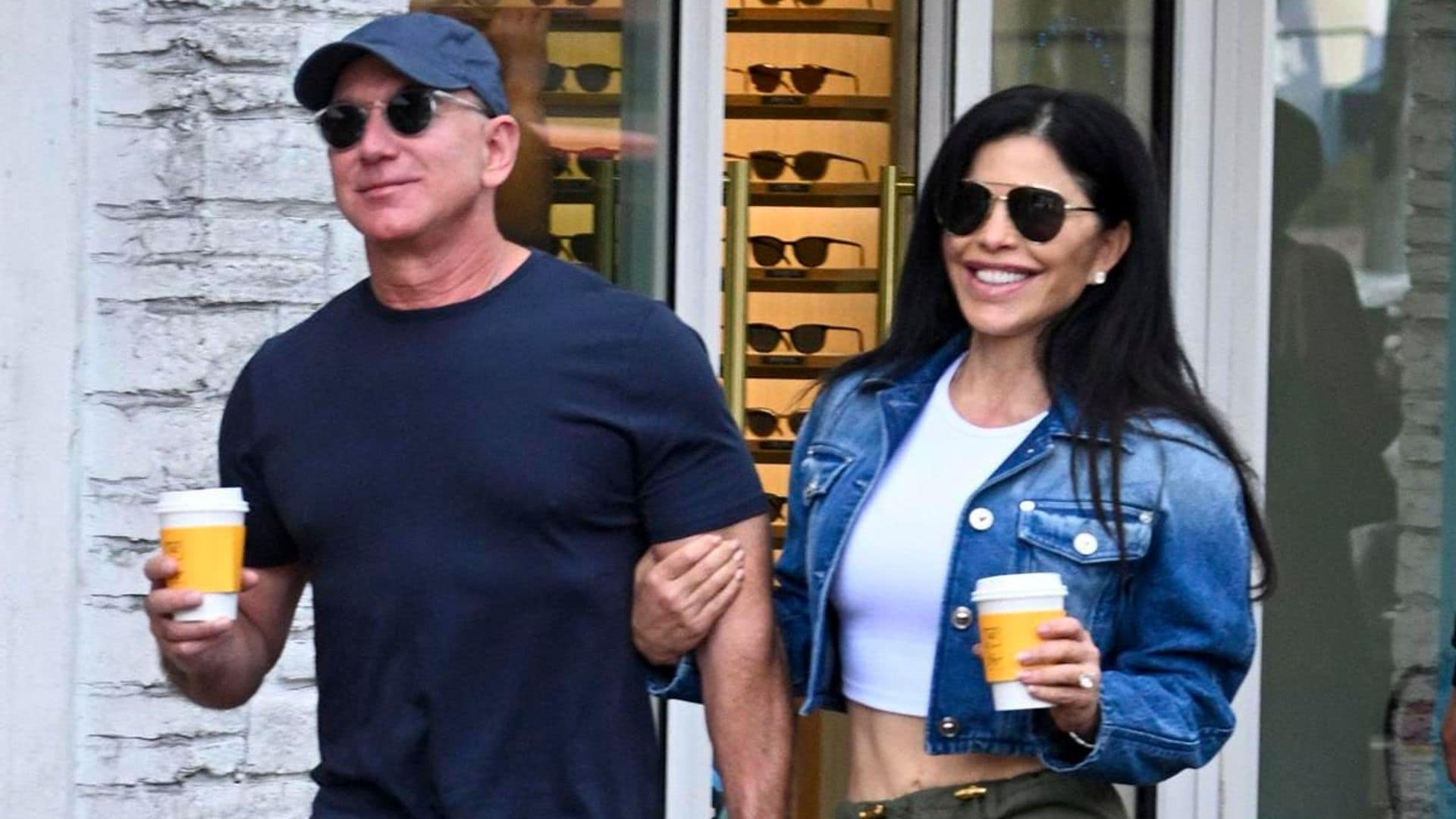 Jeff Bezos and Lauren Sanchez smile and hold on to each other at an art festival in Miami