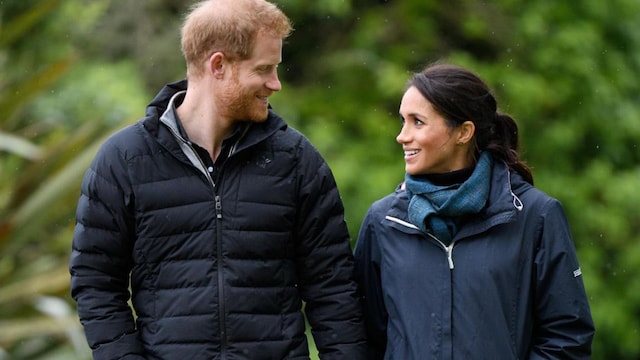 Prince Harry and Meghan Markle walk in forest park