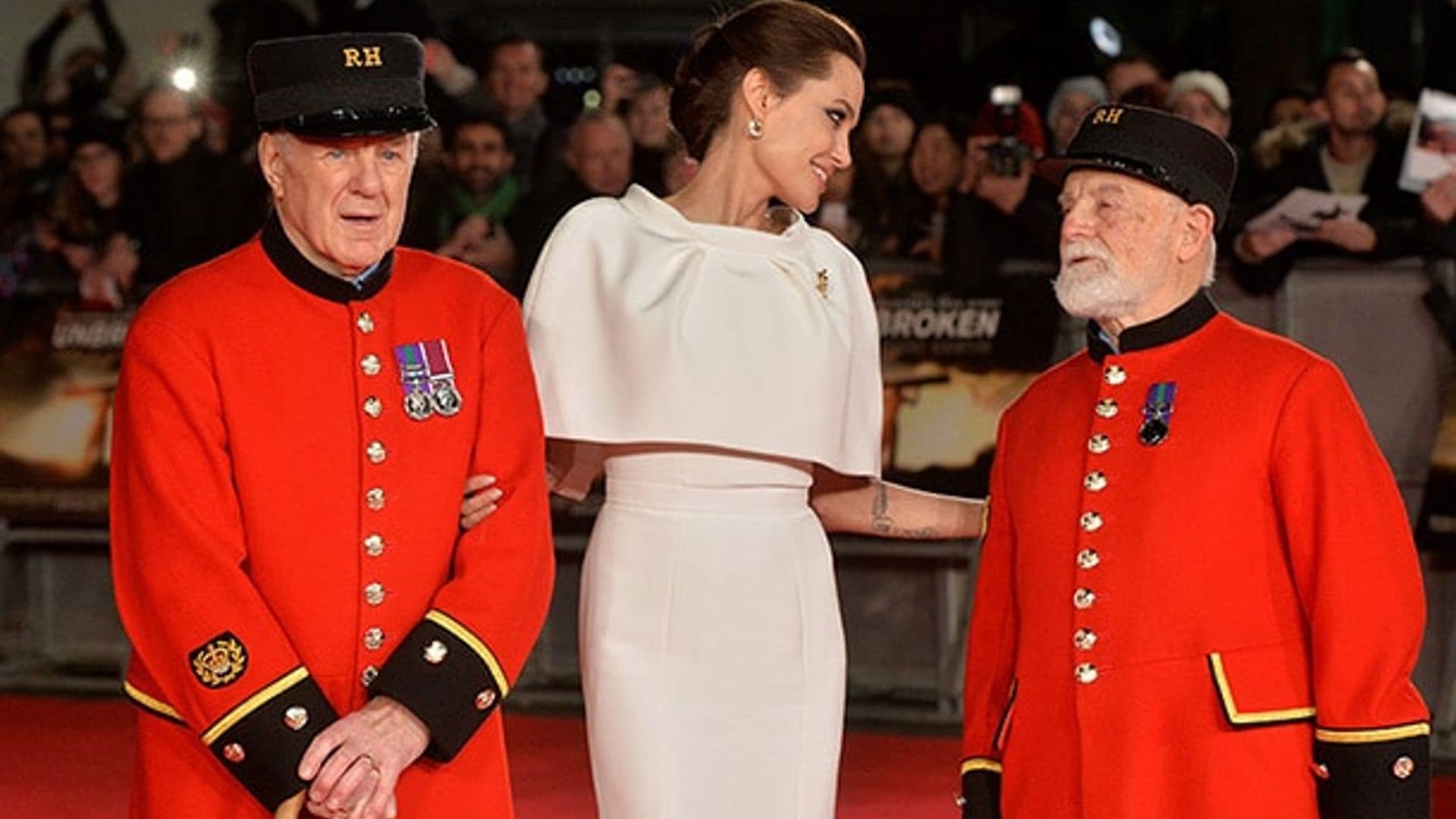 Angelina Jolie enjoys a tender moment with Chelsea pensioners, who escorted her on the red carpet