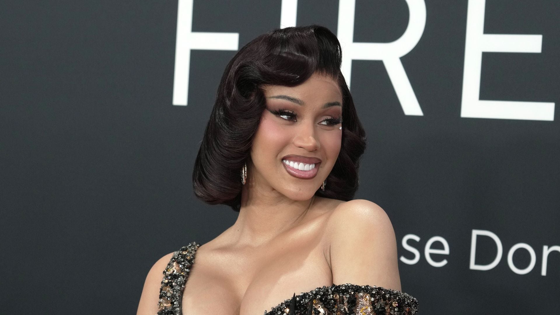 Cardi B channels old Hollywood glamour in figure-hugging gold dress at the Grammys