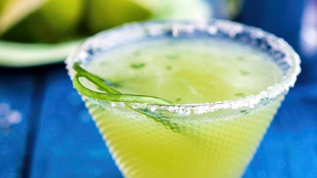 Cucumber margarita in a glass with a salt rim