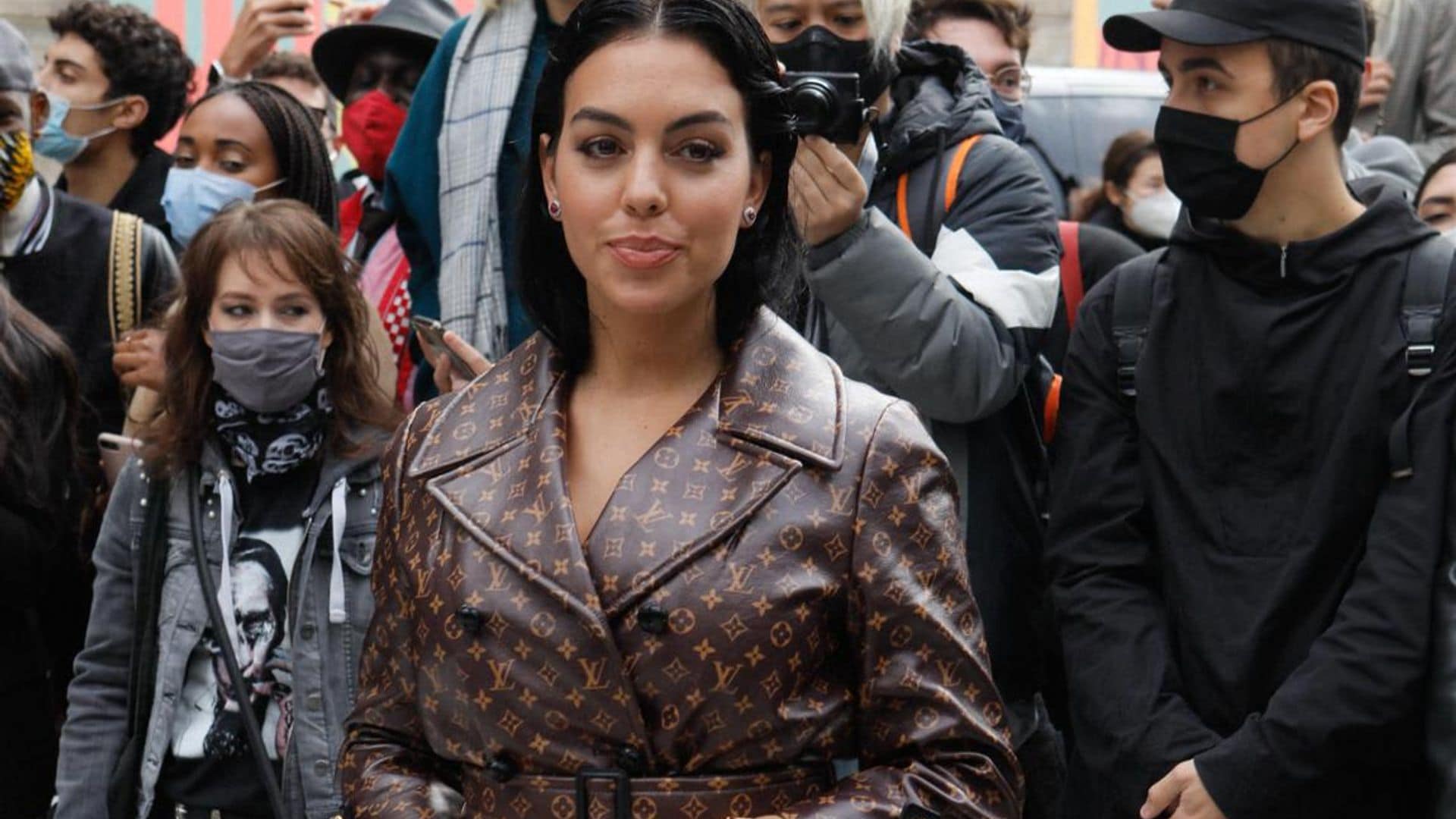 Georgina Rodriguez Represents in a $6000 Dollar Logo Trench Coat at Louis Vuitton Show