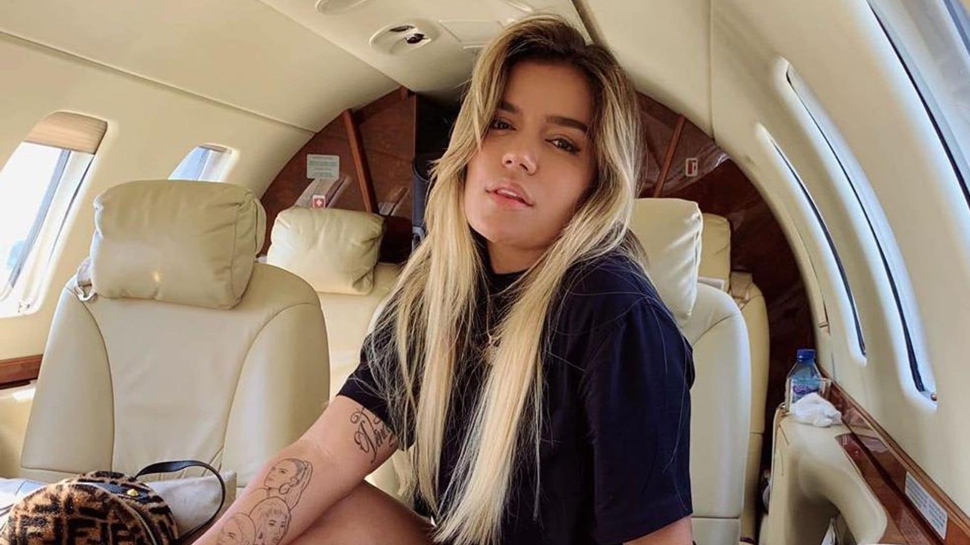 Karol G opens up her impressive closet and shares how she keeps Anuel AA close while away