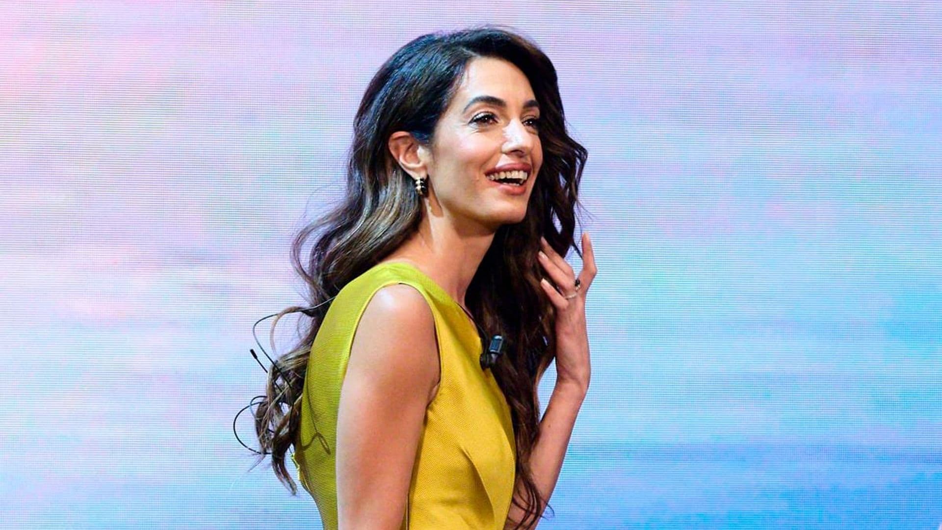 Amal Clooney wears a stunning golden jumpsuit at Madrid conference