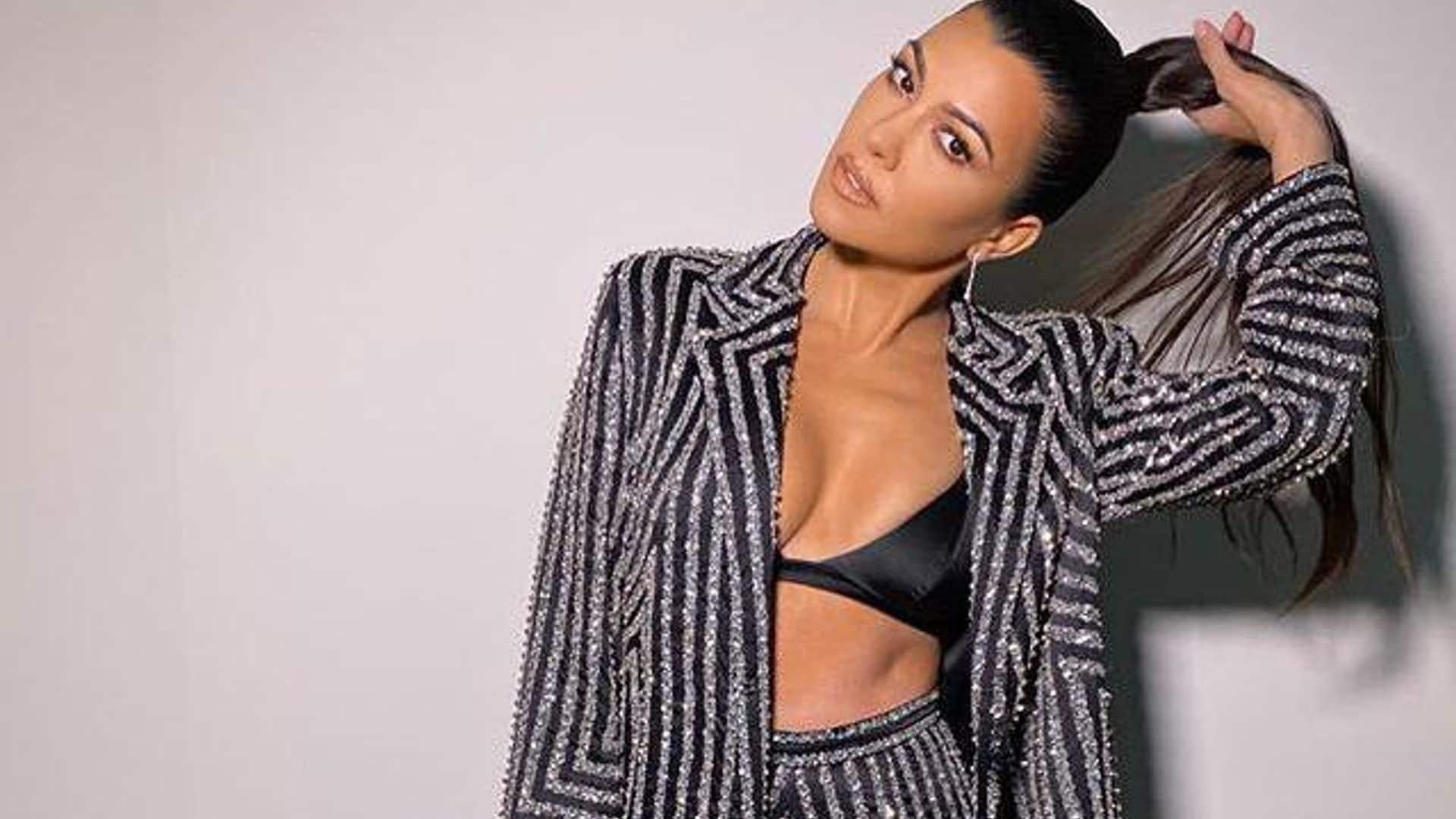 Kourtney Kardashian ditches her shirt to go out in a bra and pantsuit - would you try this trend?