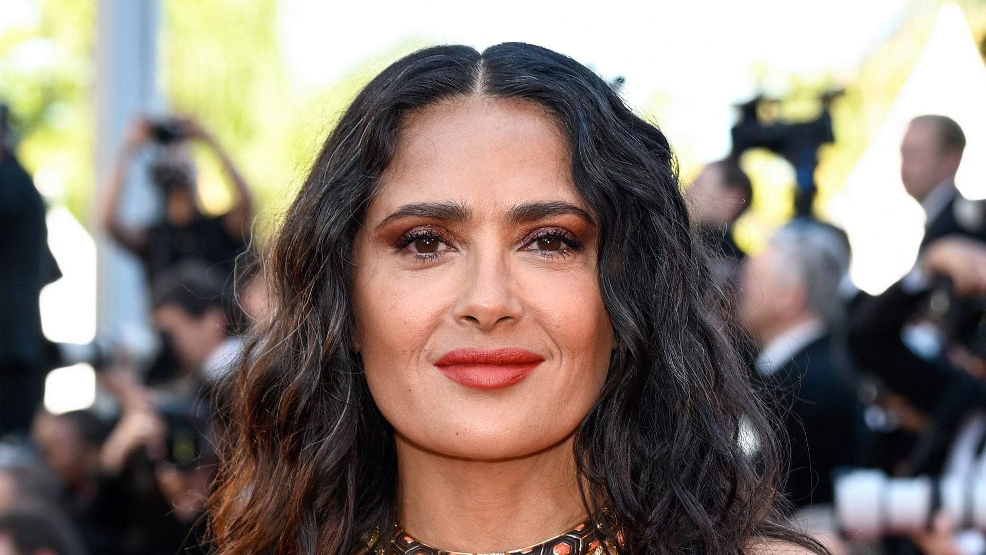 Salma Hayek and her dangerous curves dive into August in a bold bikini