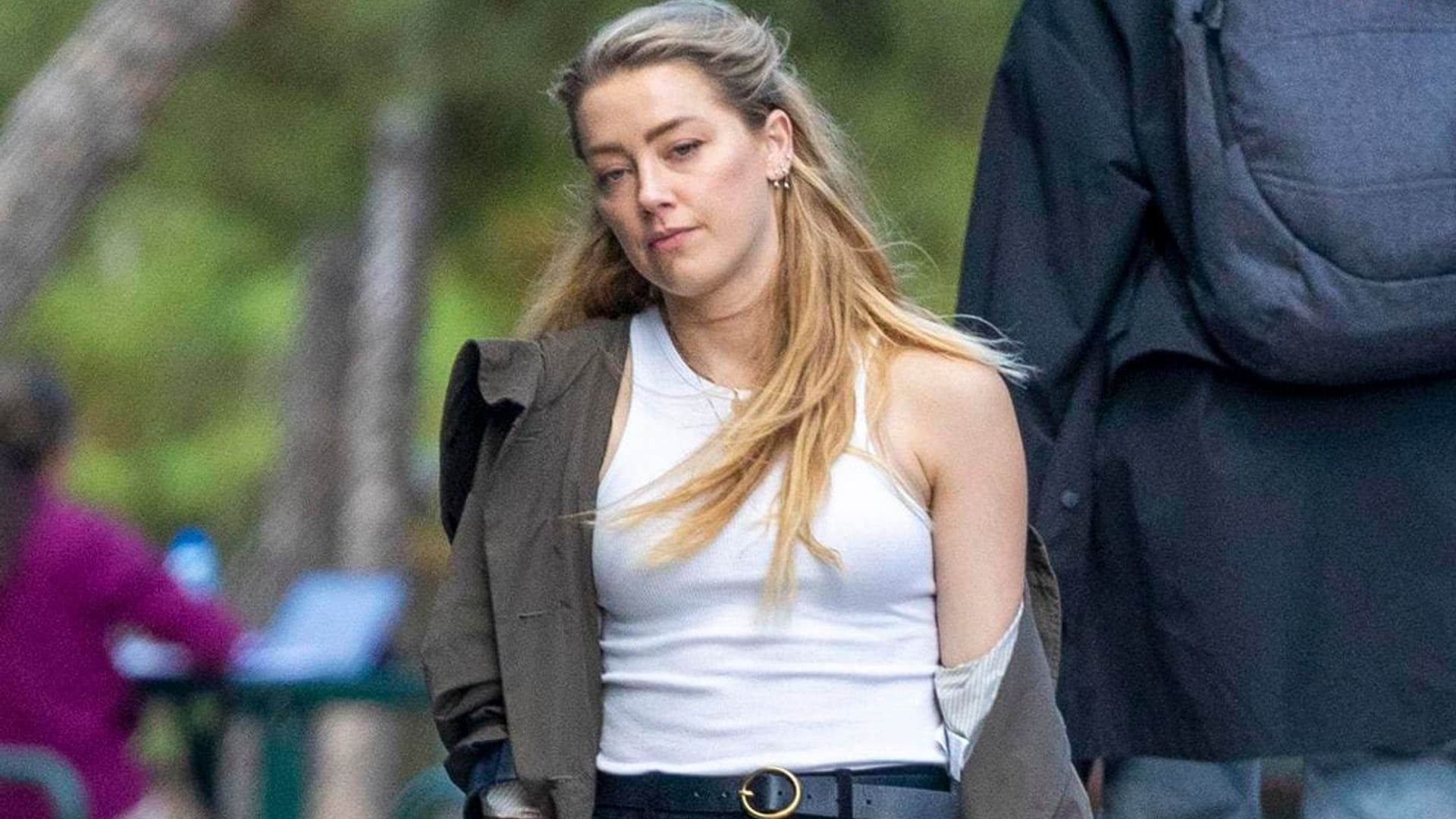 Amber Heard uses a cane while spending time with her lookalike sister