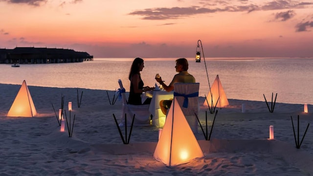 A couple enjoying a romantic meal on the beach