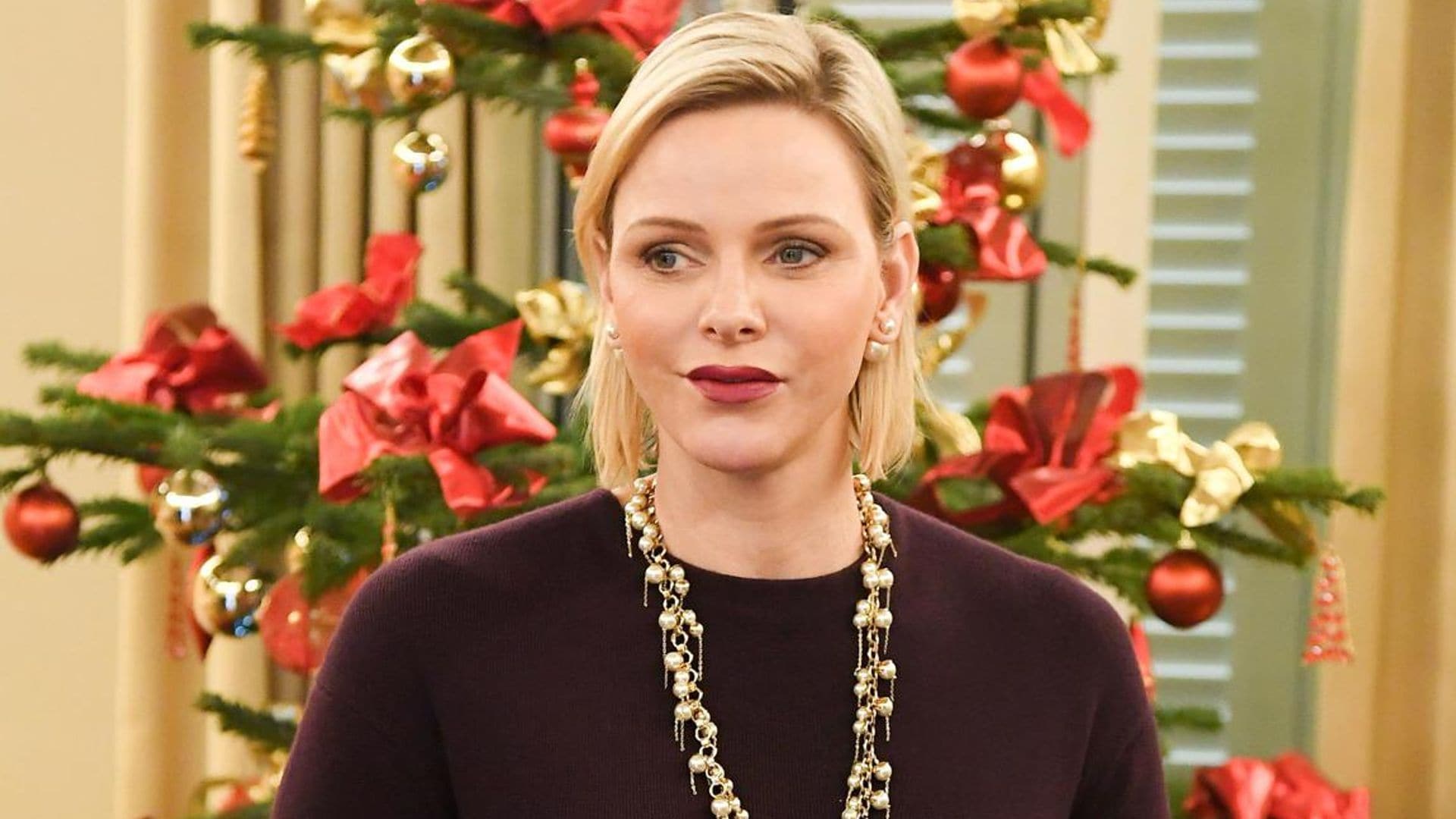 Princess Charlene wears gold and pearl statement necklace as she hands out Christmas gifts in Monaco