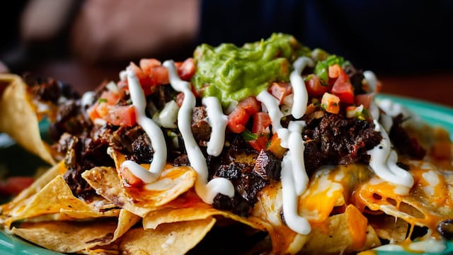 Beef and cheese corn nachos served on a big plate ready to eat