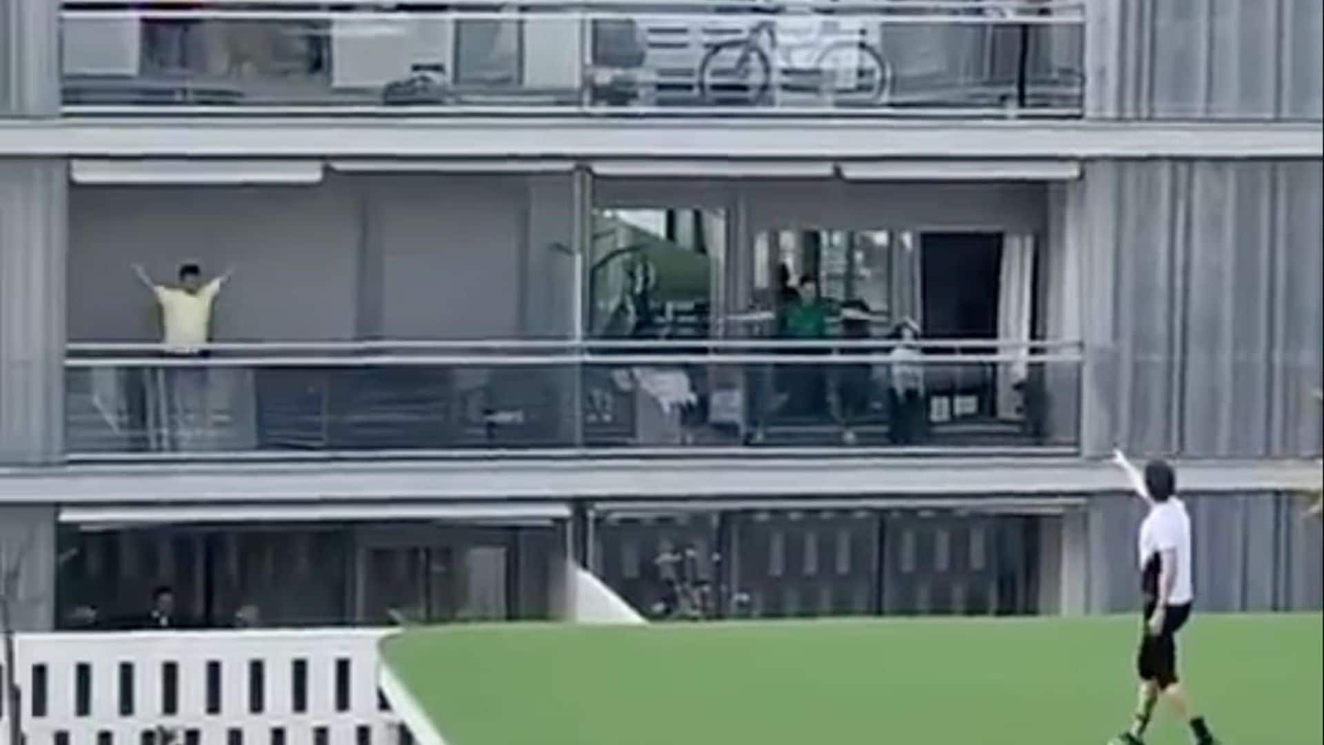 Trainer hosts workout from roof as people follow on balconies in quarantined Spain