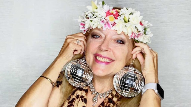 Carole Baskin DWTS Promo image, headshot with disco ball earrings