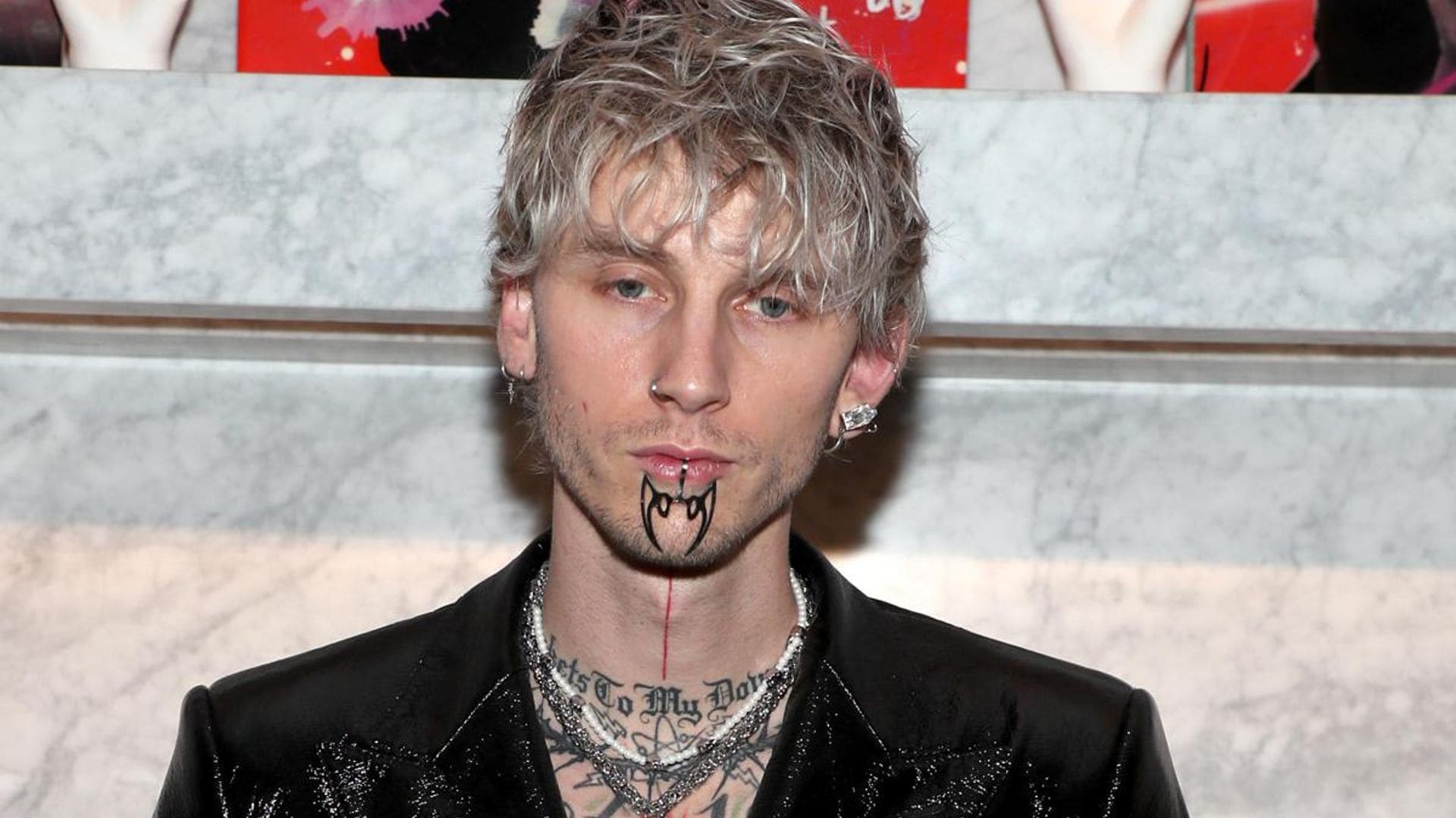 Machine Gun Kelly covers his upper body with massive blackout tattoo