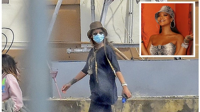 Rihanna pictured wearing a protective face mask and a lot of bling