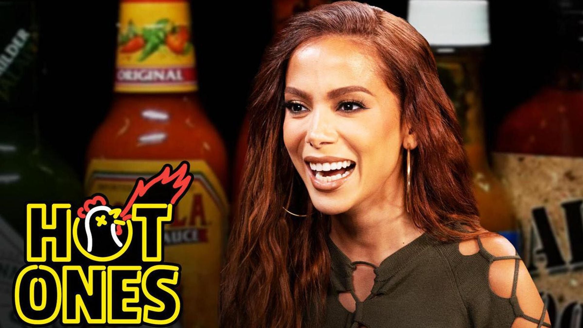 Anitta curses in Portuguese as she eats hot wings