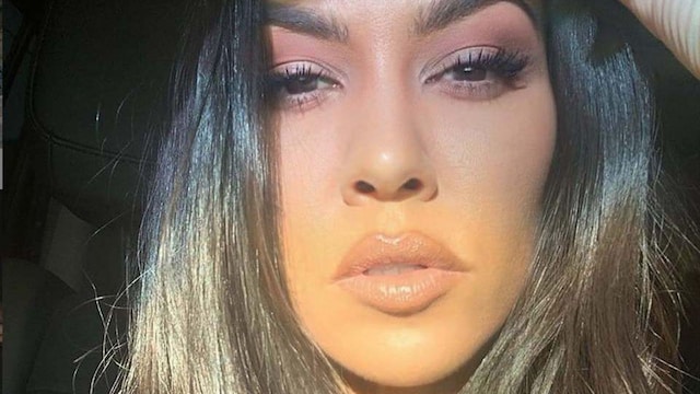 Close-up selfie of Kourtney Kardashian with shiny hair