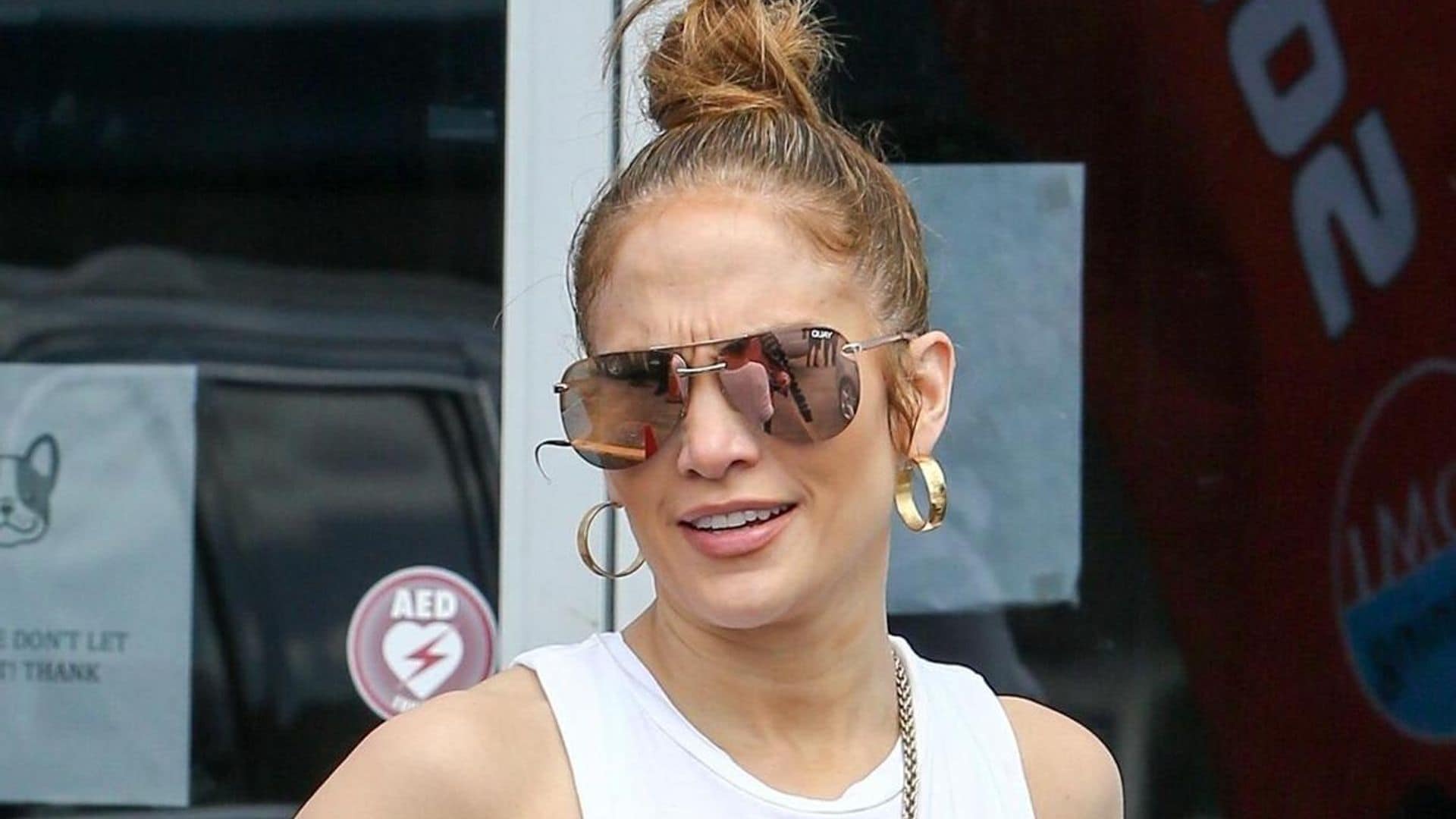 Jennifer Lopez’s monogrammed tracksuit and neon yellow mini bag is the most extra gym outfit