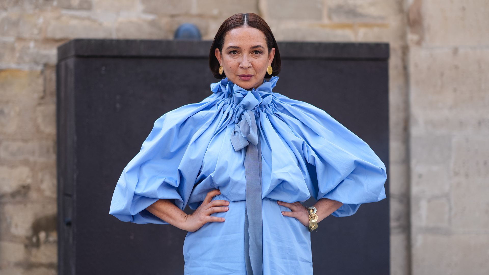 Maya Rudolph wears gold earrings, a gold bracelet, and a light blue puffy short-sleeved Patou maxi dress outside Patou during the Paris Haute Couture Week Fall/Winter 2024-2025 on June 27, 2024, in Paris, France. (Photo by Edward Berthelot/Getty Images)