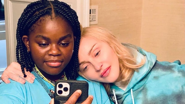 Madonna posing with her daughter Mercy James in matching blue tops.