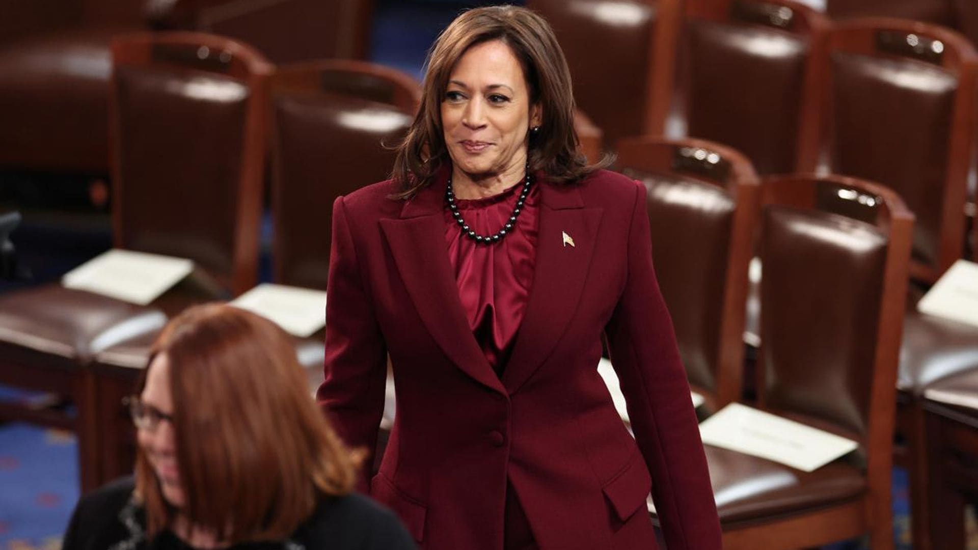 Vice President Kamala Harris wears a maroon suit designed by Christian Siriano