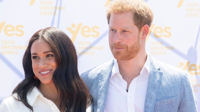 Prince Harry and Meghan Markle posing together during their visit to South Africa