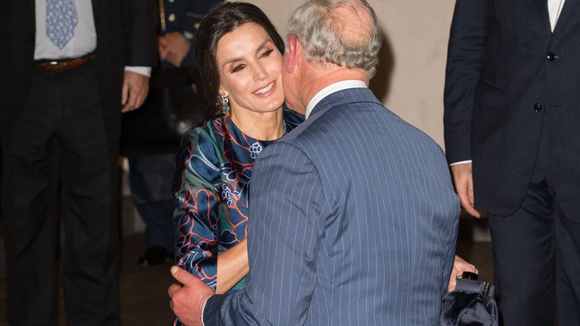 Queen Letizia gets a kiss on the cheek from Prince Charles on stylish night out