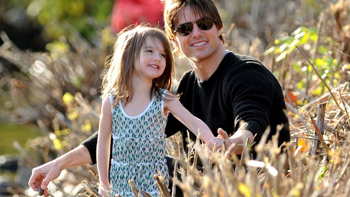 Tom Cruise is all smiles during a helicopter ride while Katie Holmes drops her daughter Suri off at college