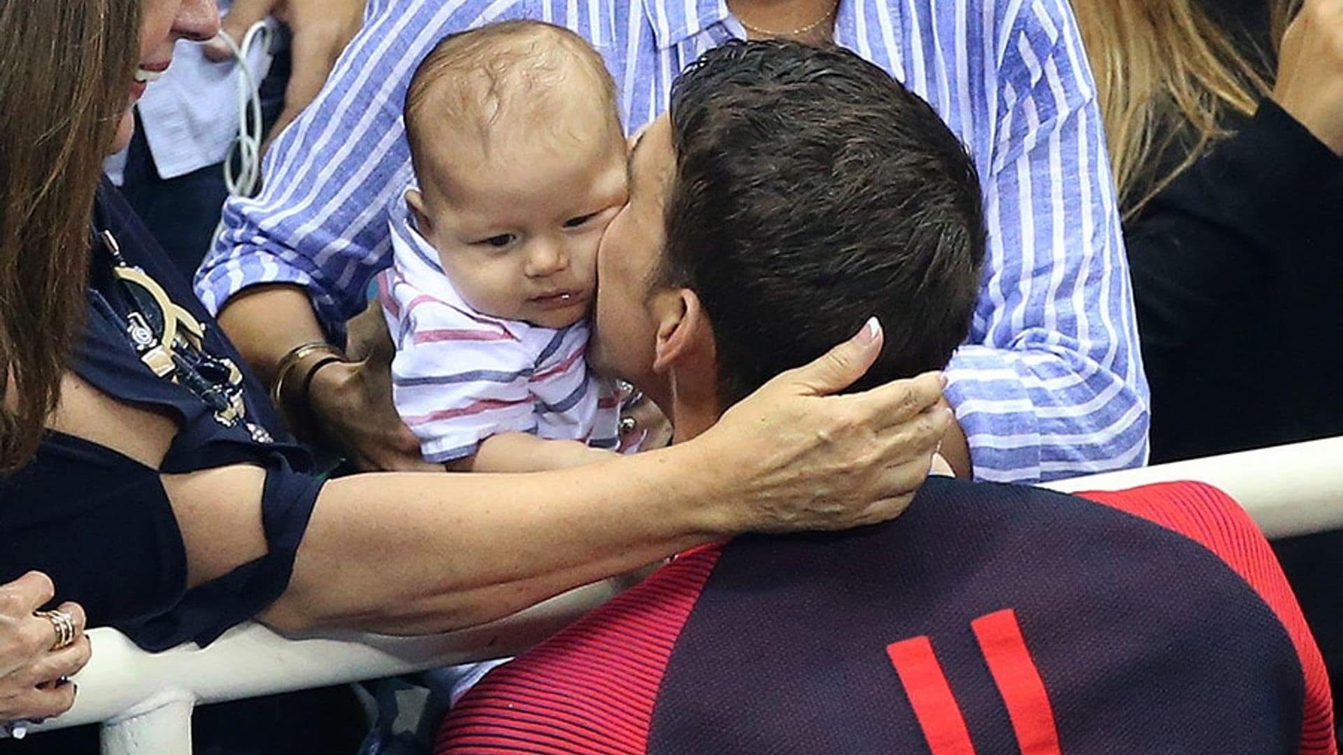 Michael Phelps celebrates Olympic gold with a kiss for baby Boomer