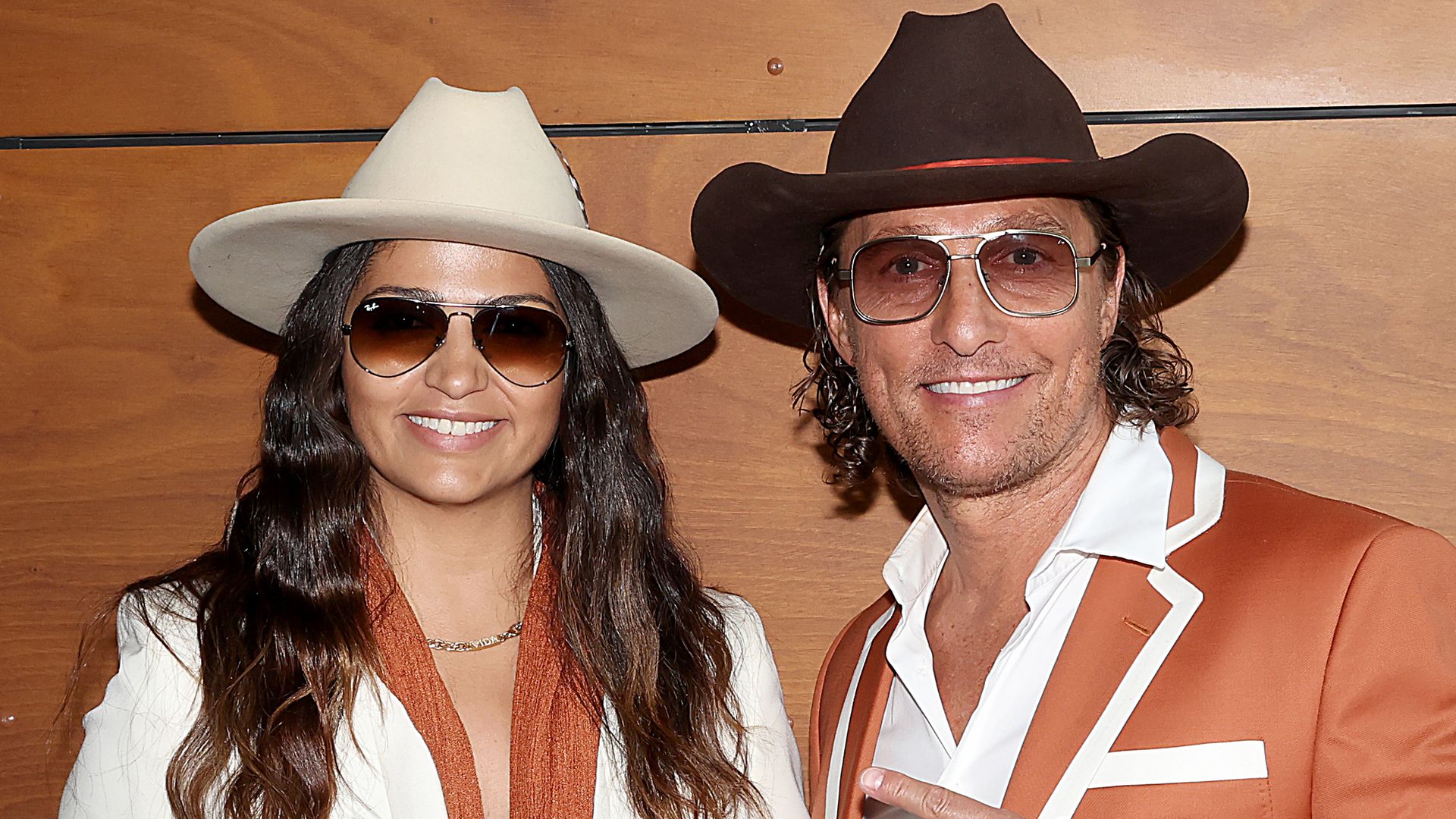 Matthew McConaughey and Camila Alves wear matching cowboy hats as they root for the Texas Longhorns