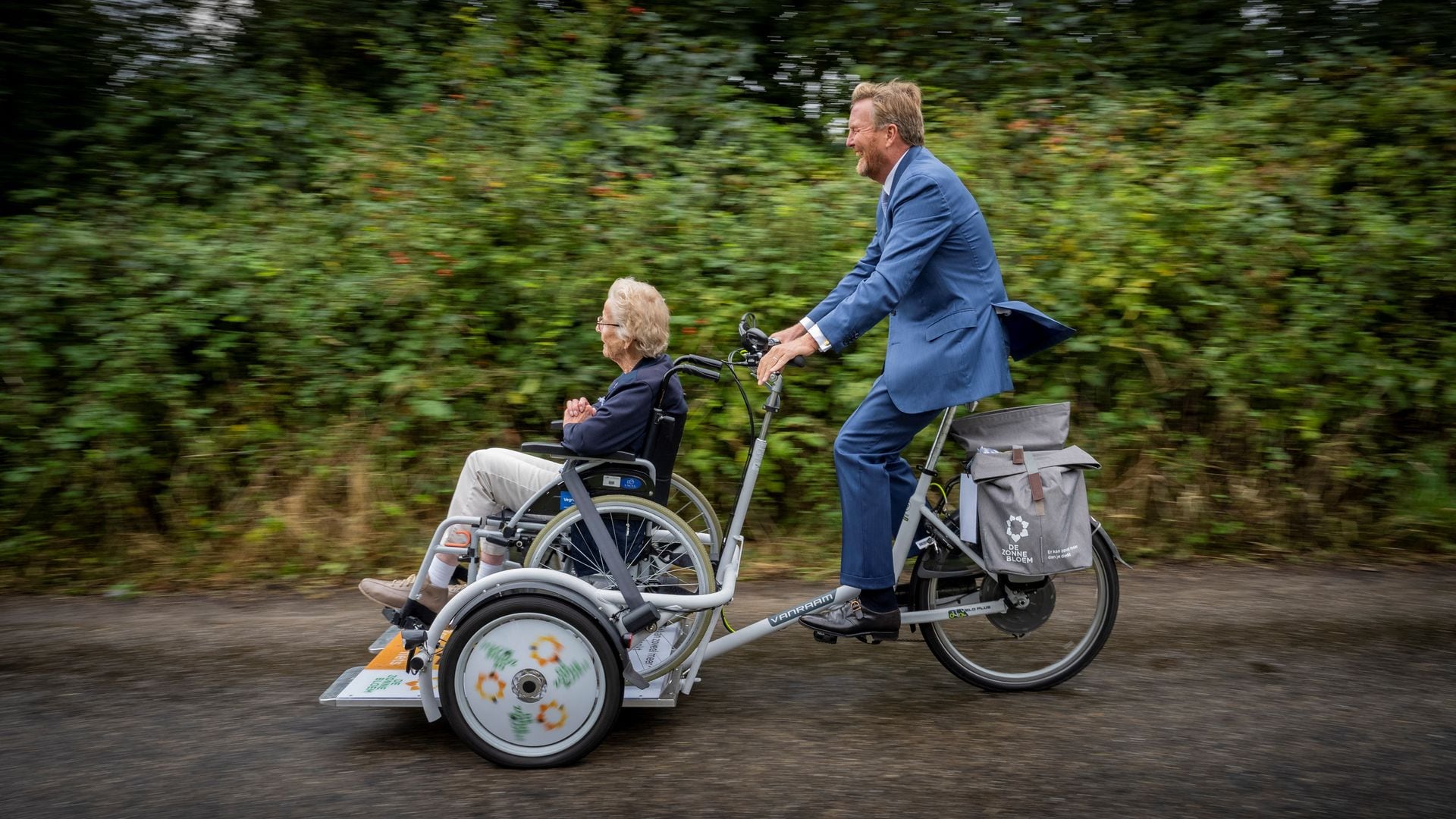 King Willem-Alexander takes a wheelchair bike for a ride: 'I hope you have fastened your seat belt'