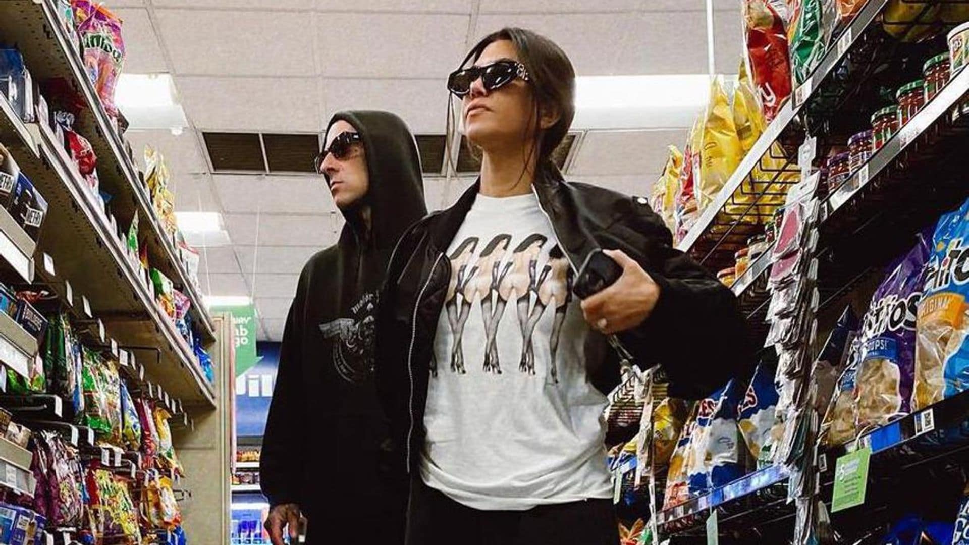 Kourtney Kardashian poses with Travis Barker at a truck stop while on tour